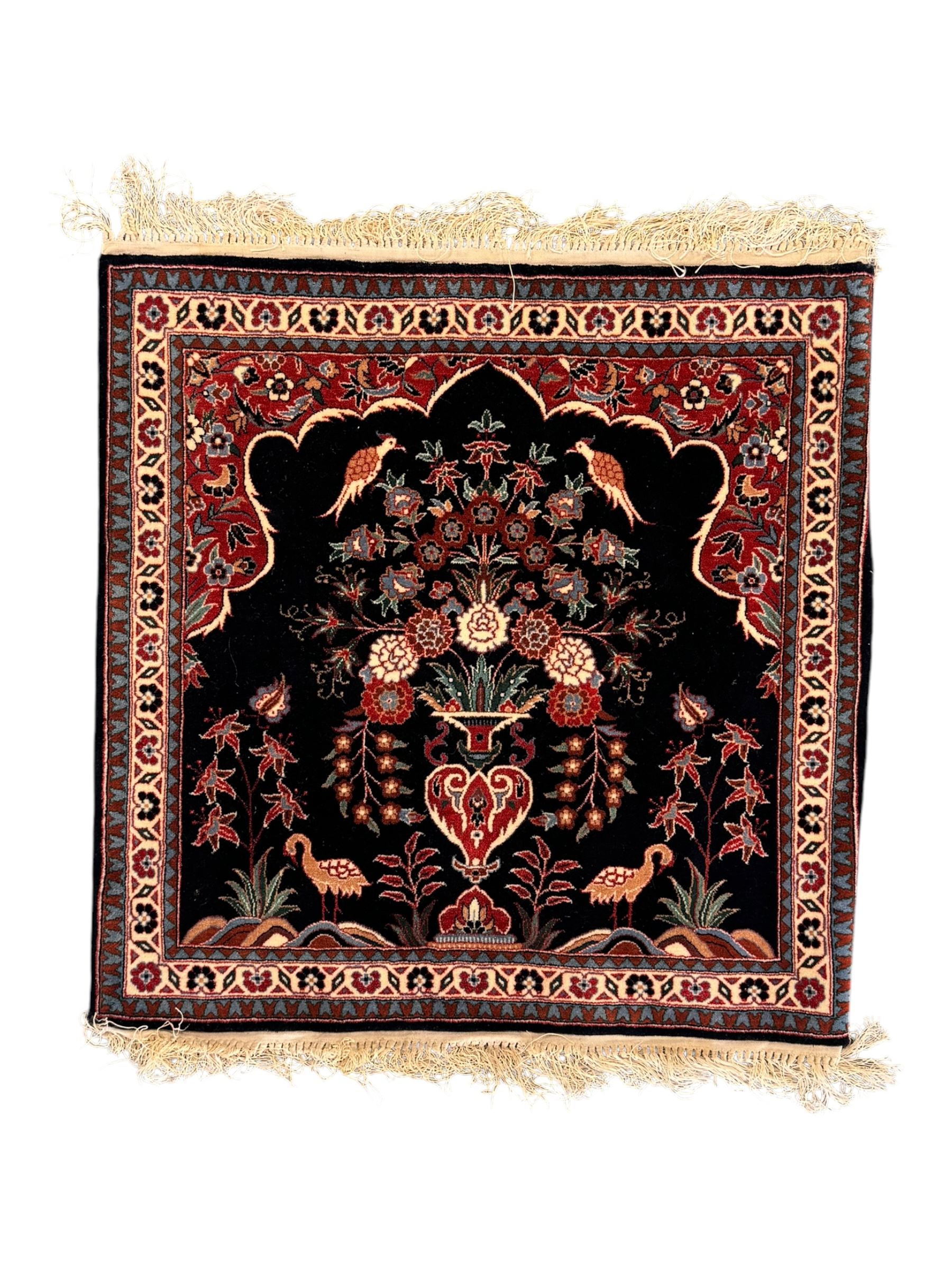 Persian-style wool rug, cream field with floral and geometric motifs, wide floral border (74cm x 142cm); Persian wool rug, beige field with dense floral patterns, narrow floral border (70cm x 144cm); Tribal wool rug, red and navy with diamond motifs (96cm x 60cm); Persian pictorial wool rug, black field with vase, birds, and floral border (70cm x 73cm)