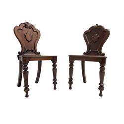 Pair of Victorian mahogany hall chairs, shaped moulded back carved with cartouche, moulded seat on turned front supports