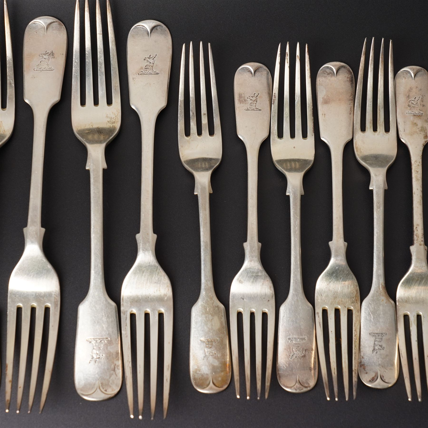 Silver Fiddle pattern canteen, composite, largely Victorian, comprising twelve table spoons, twelve table forks, twelve dessert spoons, eleven dessert forks, one soup ladle, one sauce ladle, and one serving spoon, each terminal engraved with The Everitt family Griffin crest, largely hallmarked Francis Higgins III, London 1892, soup and sauce ladle dated 1808 and 1828 

Provenance: From the collection of Andrew Chichester Everitt.




