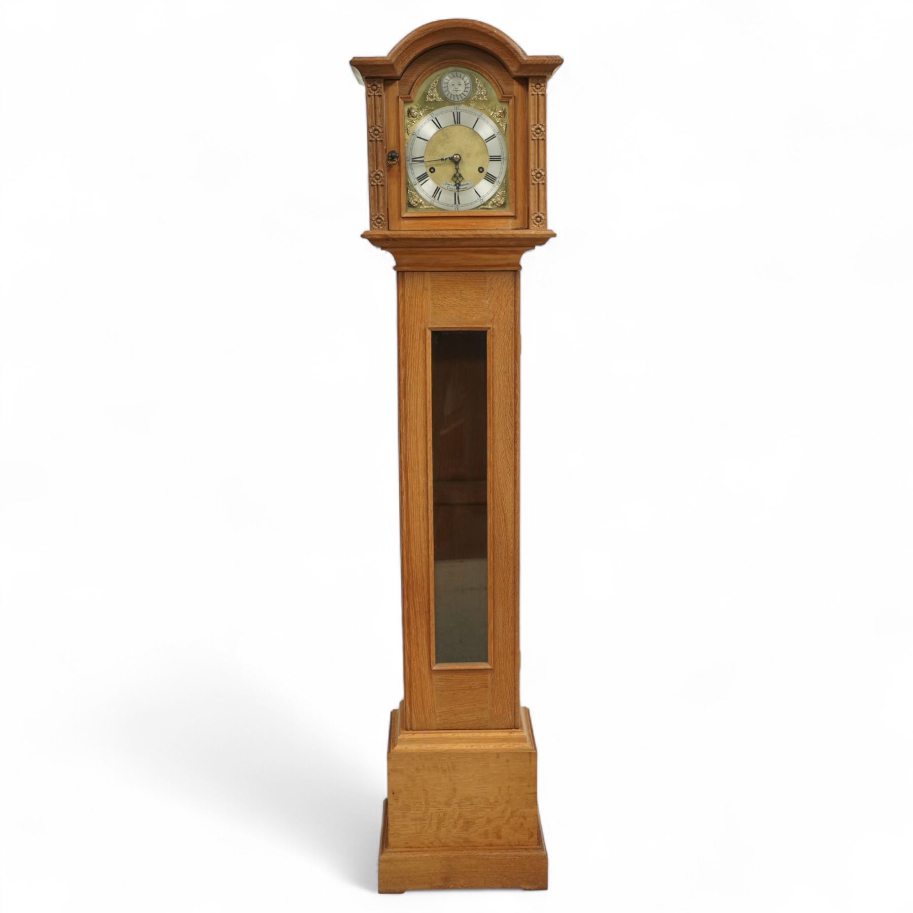 Mouseman - Oak 8-day grandmother clock, with a high quality weight driven movement and dial by Sinclair and Harding & Co of Cheltenham (No 477), brass break-arch dial with pierced steel hands, cast spandrels and a matted dial centre, silvered chapter with Roman numerals and minute track, dial pinned to  a two train rack striking movement, striking the hours on a cast bell, case with a full length glazed door and visible brass cased weights and conforming brass cased cylindrical pendulum. Signature carved mouse to the top of the arch of the case, from the workshop of Robert Thompson of Kilburn
With key.
Longcase.