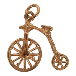 Four 9ct gold charms including penny-farthing, car, lamp and well, all hallmarked