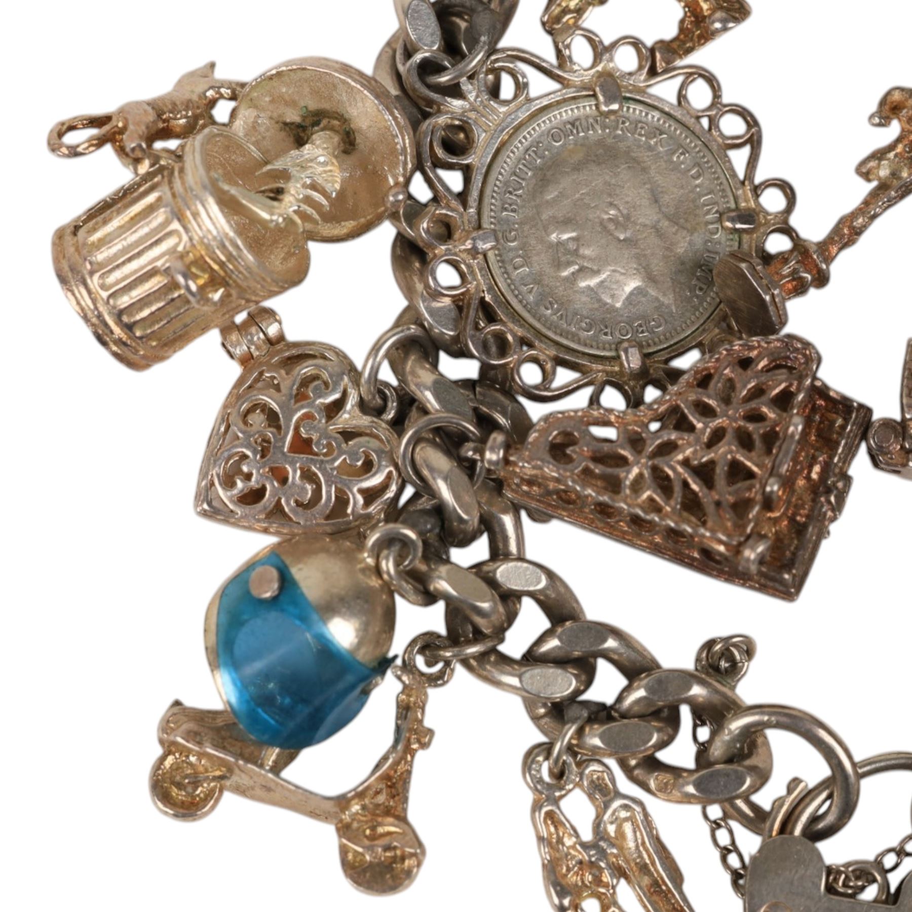 Silver charm bracelet, with seventeen charms including motorbike helmet, enamel toby jug, piano, etc
