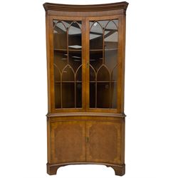 Late 20th century Georgian design mahogany concave corner display cabinet, enclosed by two curved astragal glazed doors, double cupboard below, on bracket feet