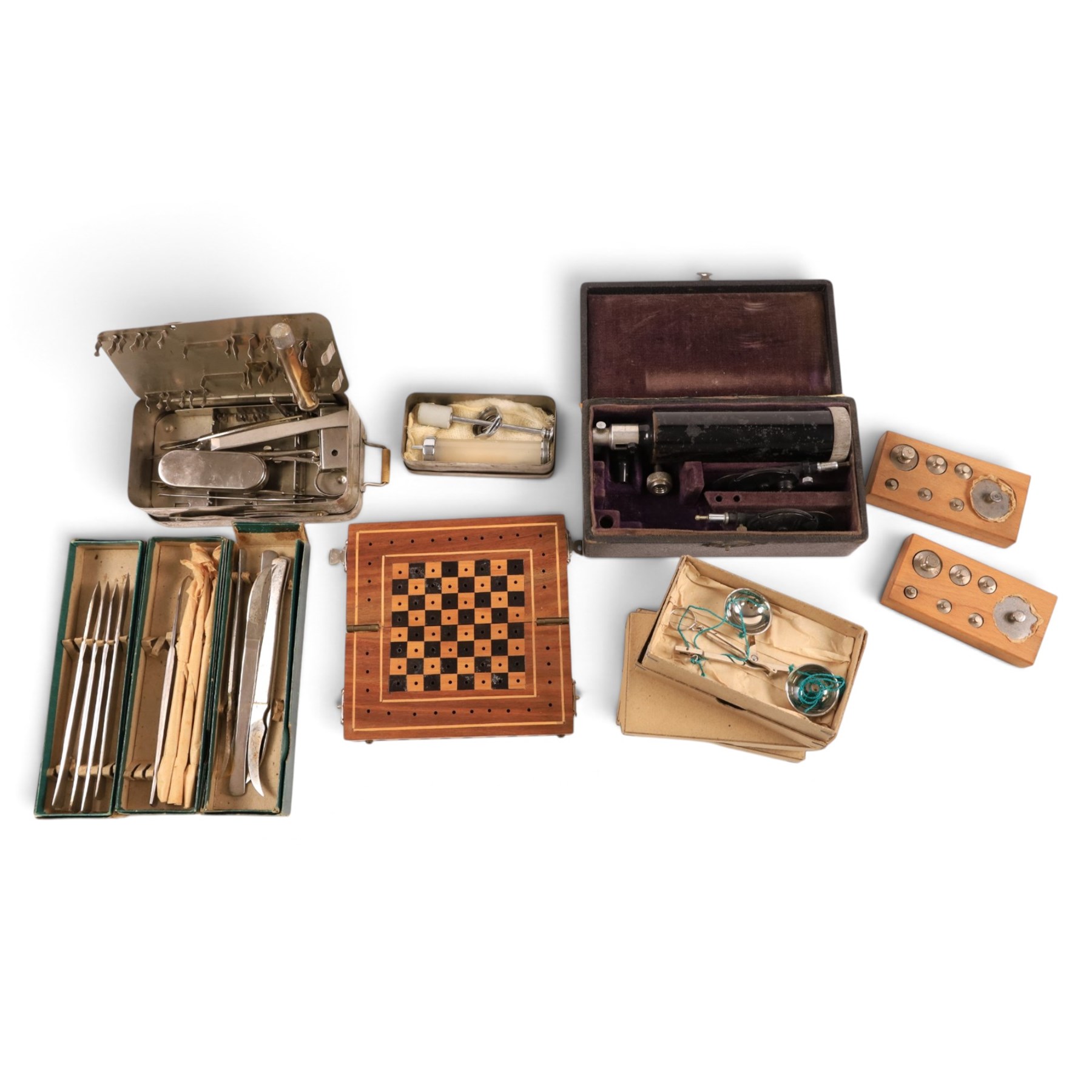 Field medical equipment, including scalpels, syringe, small weights and scales, ophthalmoscope, etc, contained within a steel uniform case