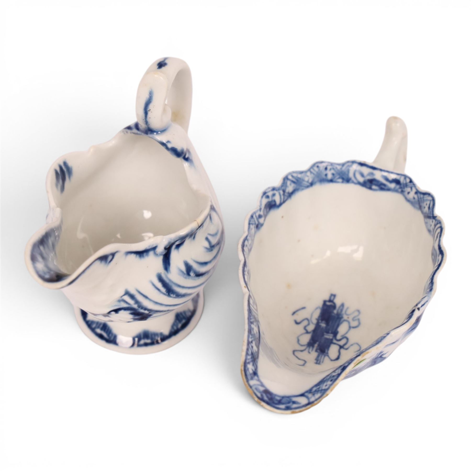 Derby blue and white dolphin ewer cream boat, circa 17750, H8cm, together with a Bow blue and white cream boat, decorated in the Desirable Residence pattern, circa 1760, L11.5cm