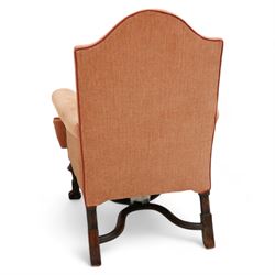 William & Mary design walnut framed armchair, arched cresting rail over rolled arms and C-scrolled arm supports, upholstered in peach herringbone fabric with contrasting rouge twist piping, on turned front feet with scrolled terminals, united by shaped and moulded X-frame stretchers with turned finial (W80cm, H106cm, D80cm); together with a Georgian design mahogany footstool, in matching upholstery with stud band, on acanthus leaf carved cabriole supports with ball and claw feet (60cm x 47cm, H47cm)