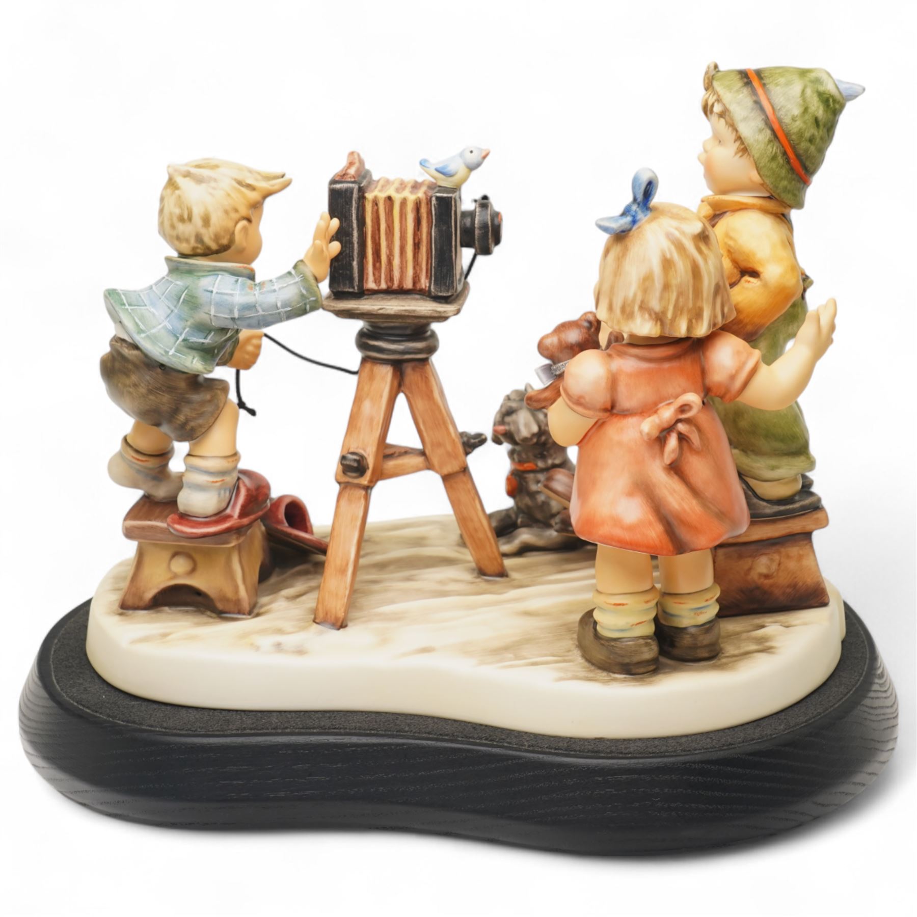 Goebel M I Hummel Club limited edition 25th Anniversary Group figurine 'Picture Perfect', numbered 552/2500, modelled as four children taking a photograph, with stand and plaque, printed marks to base, excluding plinth W27cm 