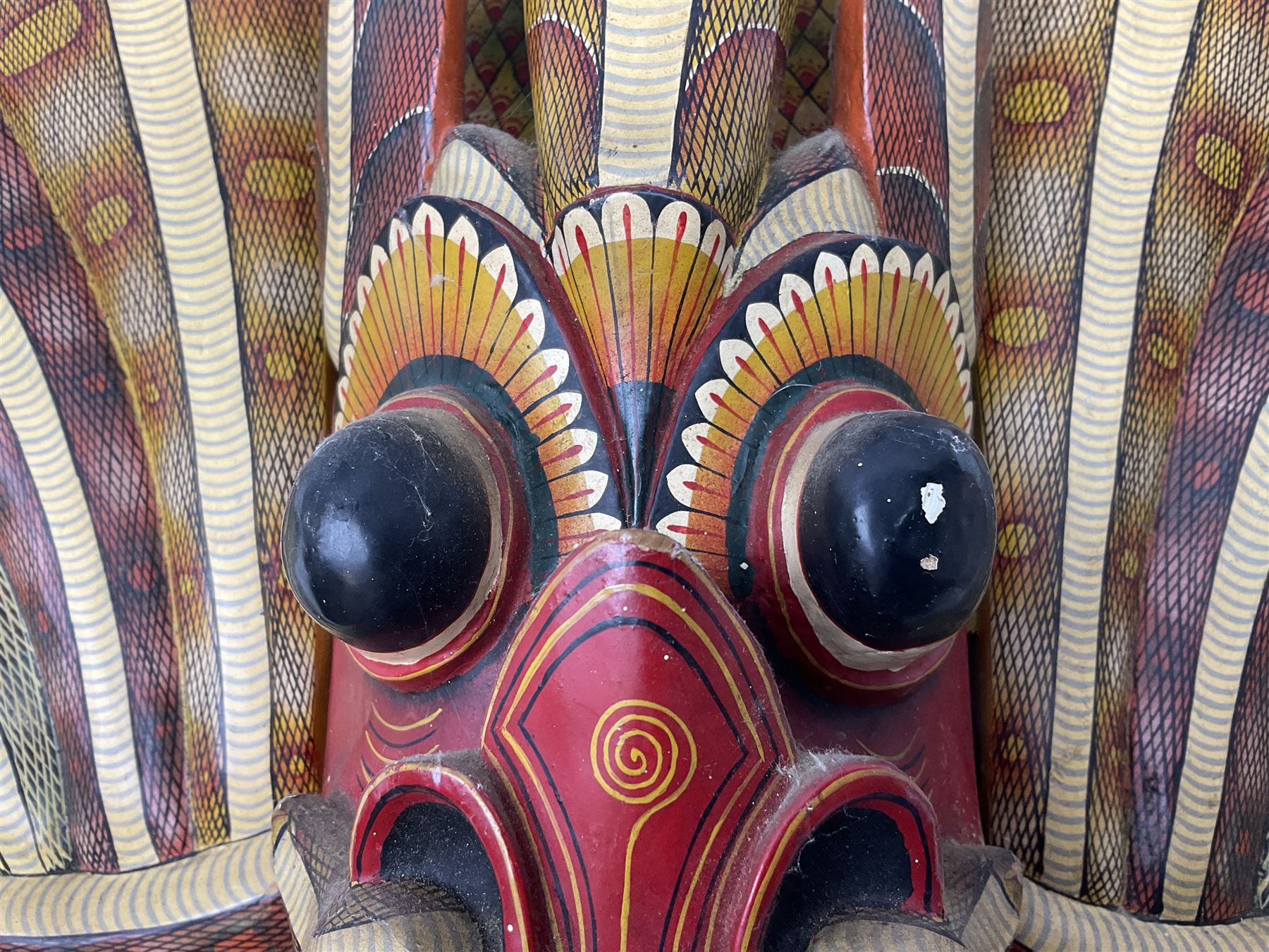 Sri Lankan Cobra mask depicting the demon Naga Raksha, together with a smaller example, largest H46cm