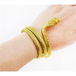 18ct gold coiled diamond snake bangle, the head set with round cut diamonds and emerald eyes, to an expanding articulated body, stamped Brevete S.G.D.G.