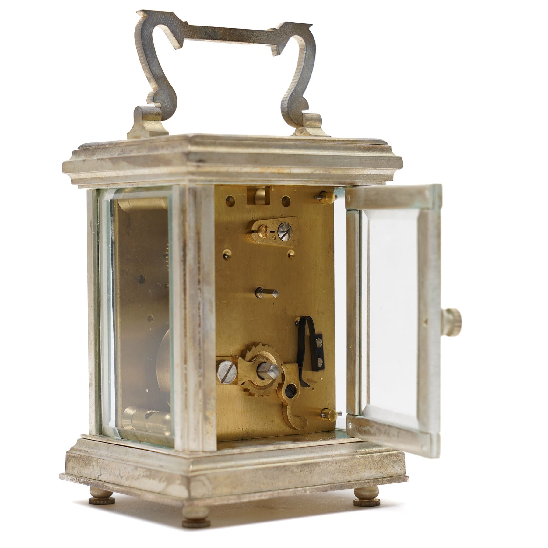 20th century- Silver plated miniature carriage clock in an anglaise case with an enamel dial, Roman numerals, minute track and pieced steel hands, with an oval viewing glass to the lever platform escapement.