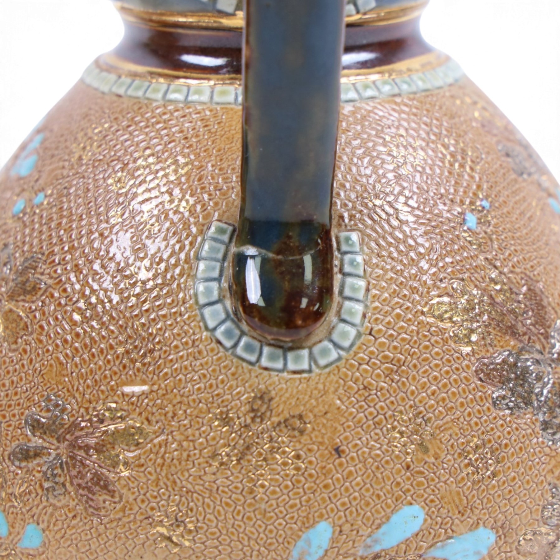 Pair of Doulton Lambeth ewers, decorated with a lace-impressed body decorated with floral sprigs, H16cm
