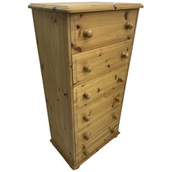 Traditional pine tall chest, fitted with six long drawers with turned handles. on compressed bun feet