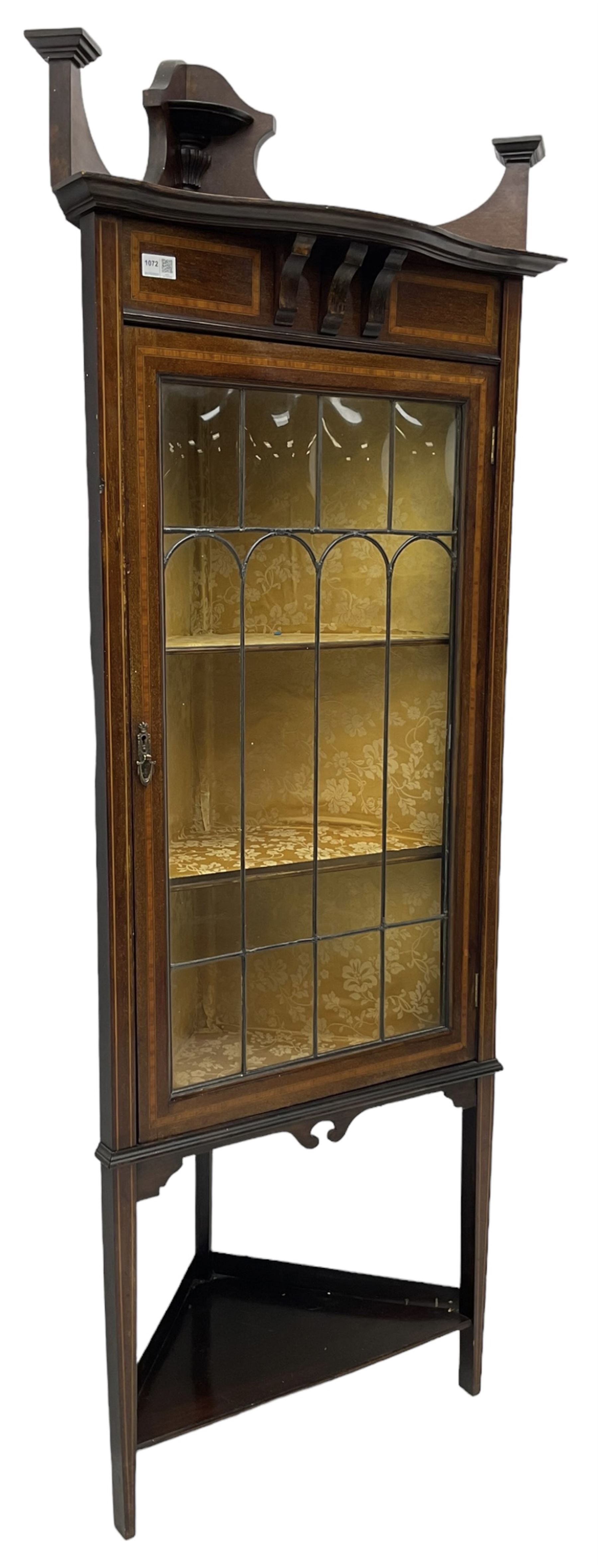 Edwardian inlaid mahogany corner cabinet, fitted with single astragal glazed door enclosing two shelves, flanked by satinwood banding, on square tapering supports united by undertier