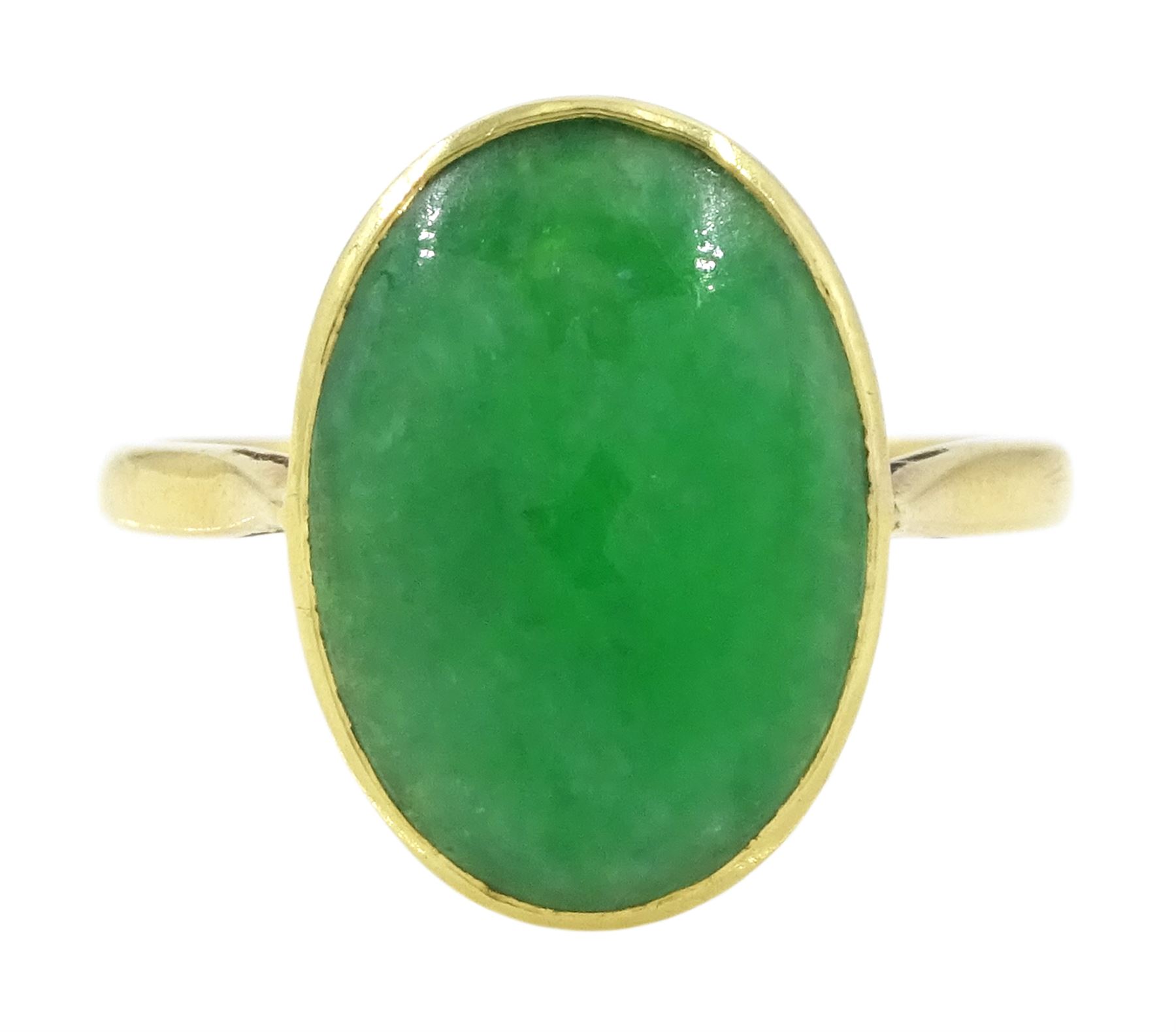 Early - mid 20th century gold jade ring, bezel set with a single oval cabochon jade of approx 4.10 carat, stamped 18ct