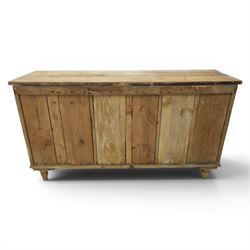 Victorian waxed pine farmhouse dresser, featuring seven drawers with central cupboard, moulded glass handles, raised on turned feet