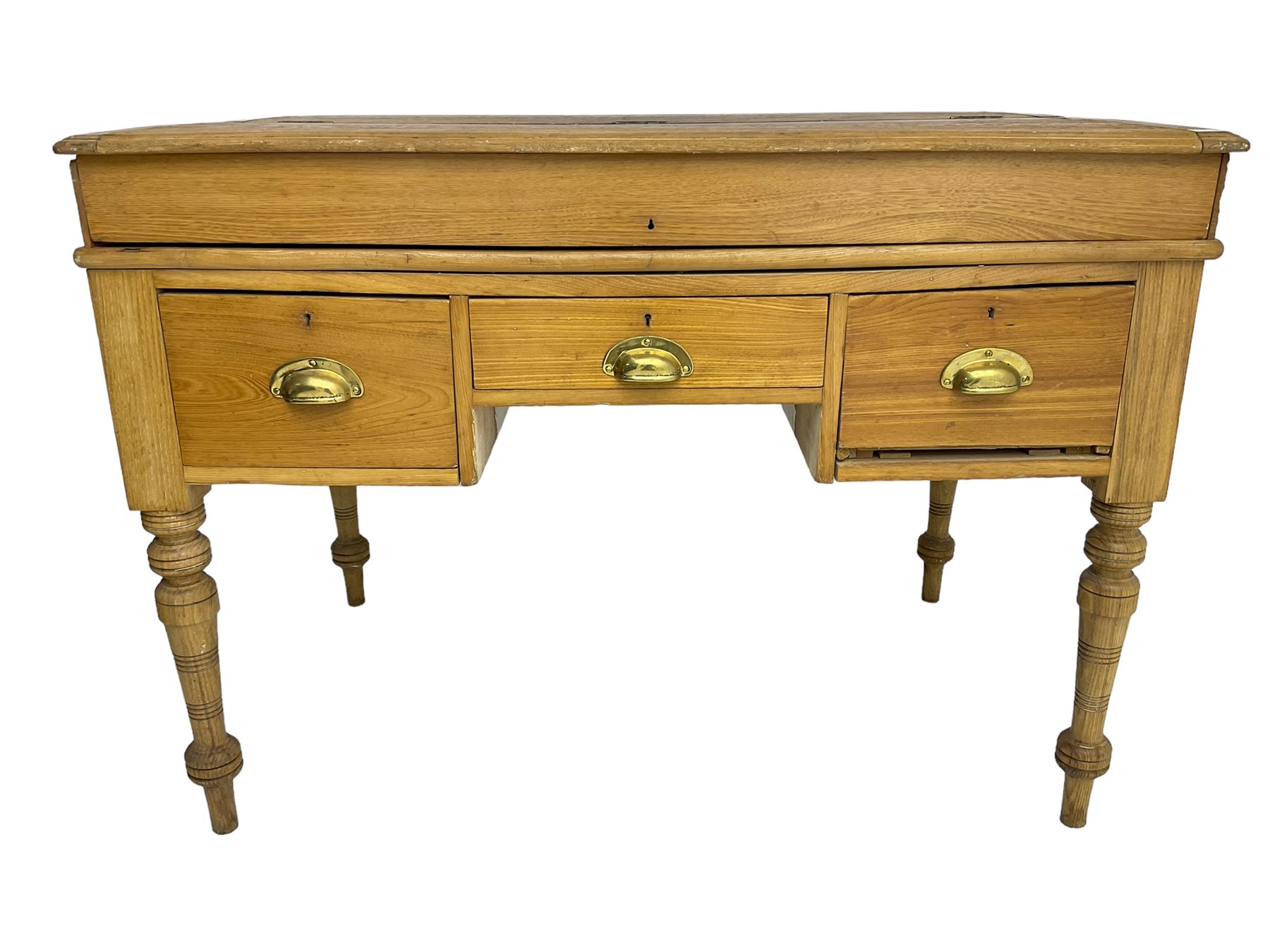 Early 20th century light oak kneehole desk, rectangular hinged top, fitted with frieze drawer flanked by two deep drawers, raised on ring turned supports