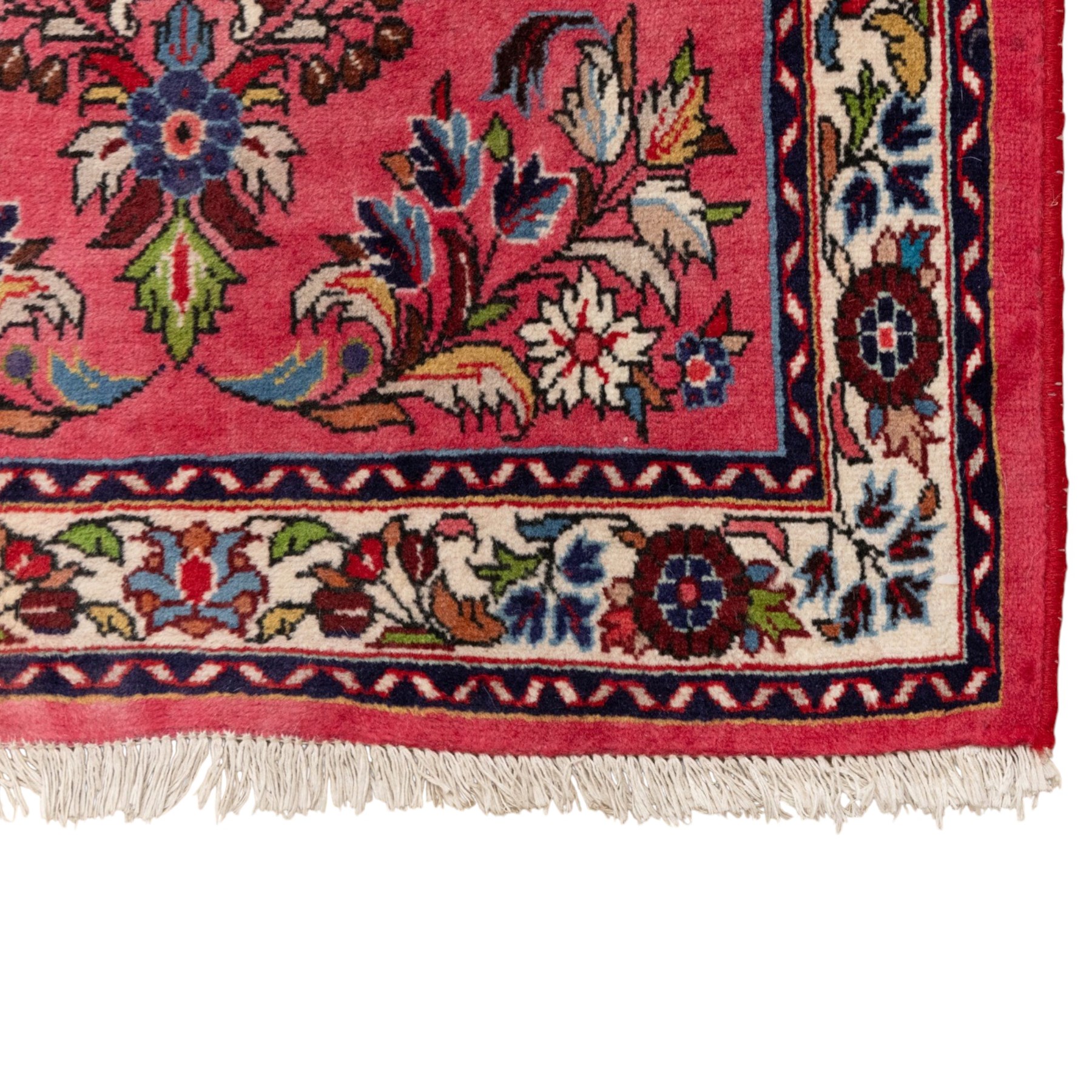 Persian rose ground runner rug, the field decorated with repeating polychrome floral sprays and scrolling palmettes, enclosed by an ivory floral border and narrow navy geometric guard stripes