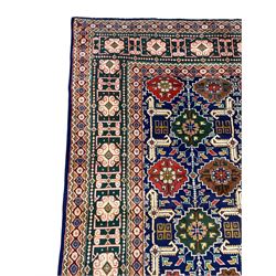 Persian Tabriz indigo ground rug, overall Quba design, decorated with repeating stylised plant motifs and interlaced with trailing leaf motifs, repeating border within geometric guard stripes