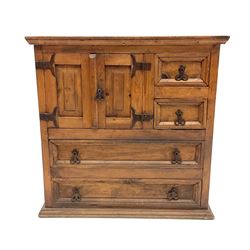 Pine chest, two short drawers flanked by two cupboard doors above two long drawers, platform base 