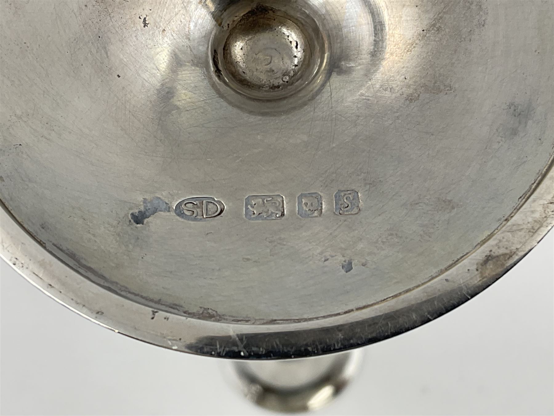 Pair of modern silver candlesticks by Stuart Devlin, the tapering parcel gilt stems with signature textured detailing, each supporting a fluted candle holder and upon a spreading circular foot, hallmarked Stuart Devlin, London 1973, H25cm