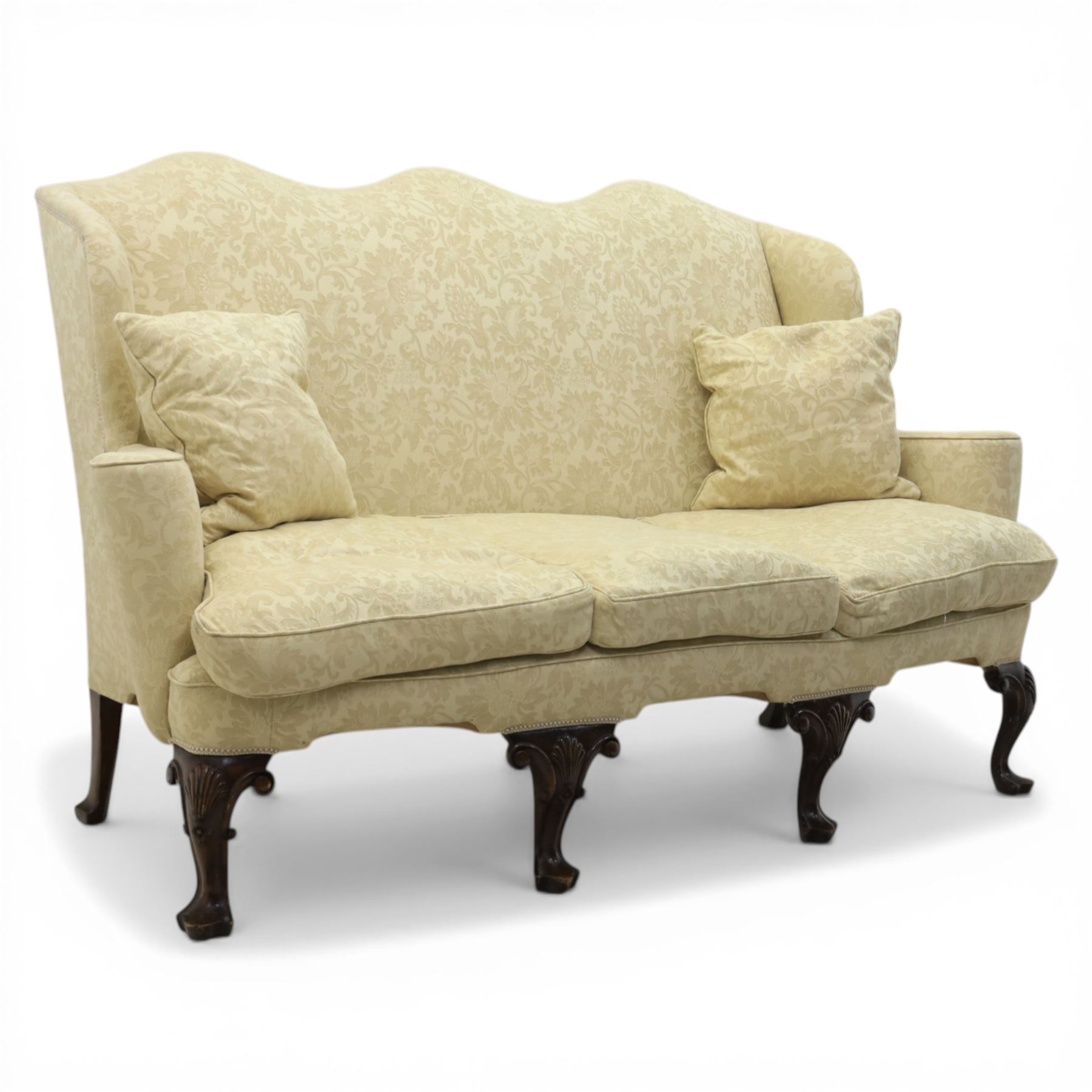 19th century Queen Anne style cream foliate upholstered three seat settee, the shaped and waisted back with serpentine cresting, padded arms over loose seat cushions, raised upon carved cabriole supports with shell carved knees