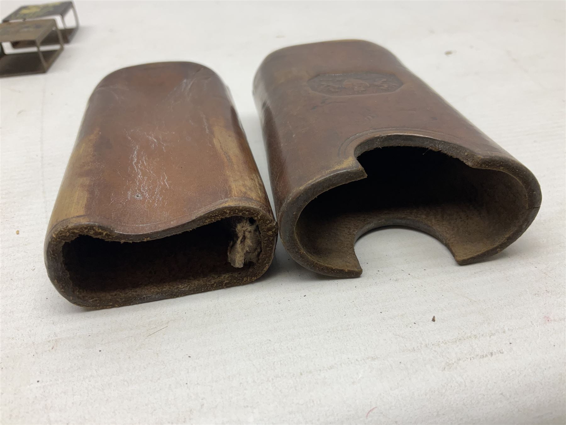 Victorian leather cigar protector with metal match striking plate on the end and internal spring to hold the cigars in place; expands for differing lengths of cigar, minimum L12.5cm; another similar leather cigar case marked Middlemore's Patent with attached vesta case and striker; three Bryant & Mays tin-late matchbox holders including 1935 Jubilee; and small box of matches (6)