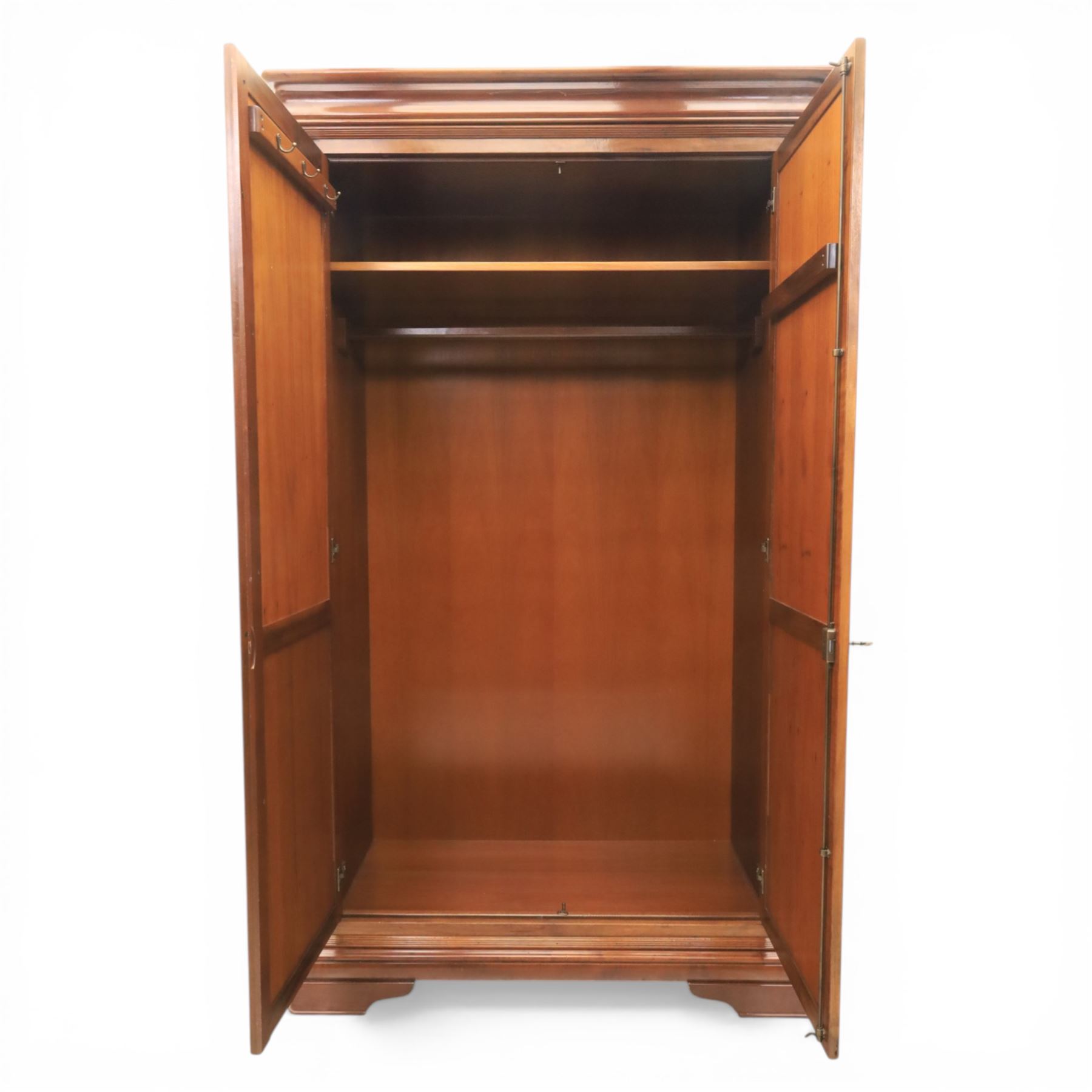 Willis & Gambier - French cherry double wardrobe, moulded cornice above panelled doors, enclosing a shelf and wooden hanging rail, raised on a moulded plinth with bracket feet