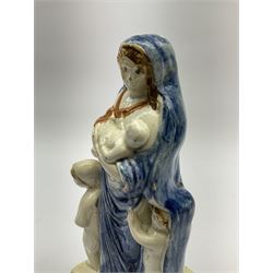 Late 18th century Prattware figure representing Charity, modelled as a mother with baby in her arms and two small children clutching at her robes, upon a square base, overall H21cm.
