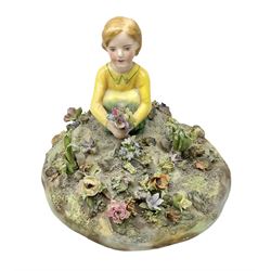 Crown Staffordshire figure modelled as a child in a garden, modelled by T Bayley, H15cm 