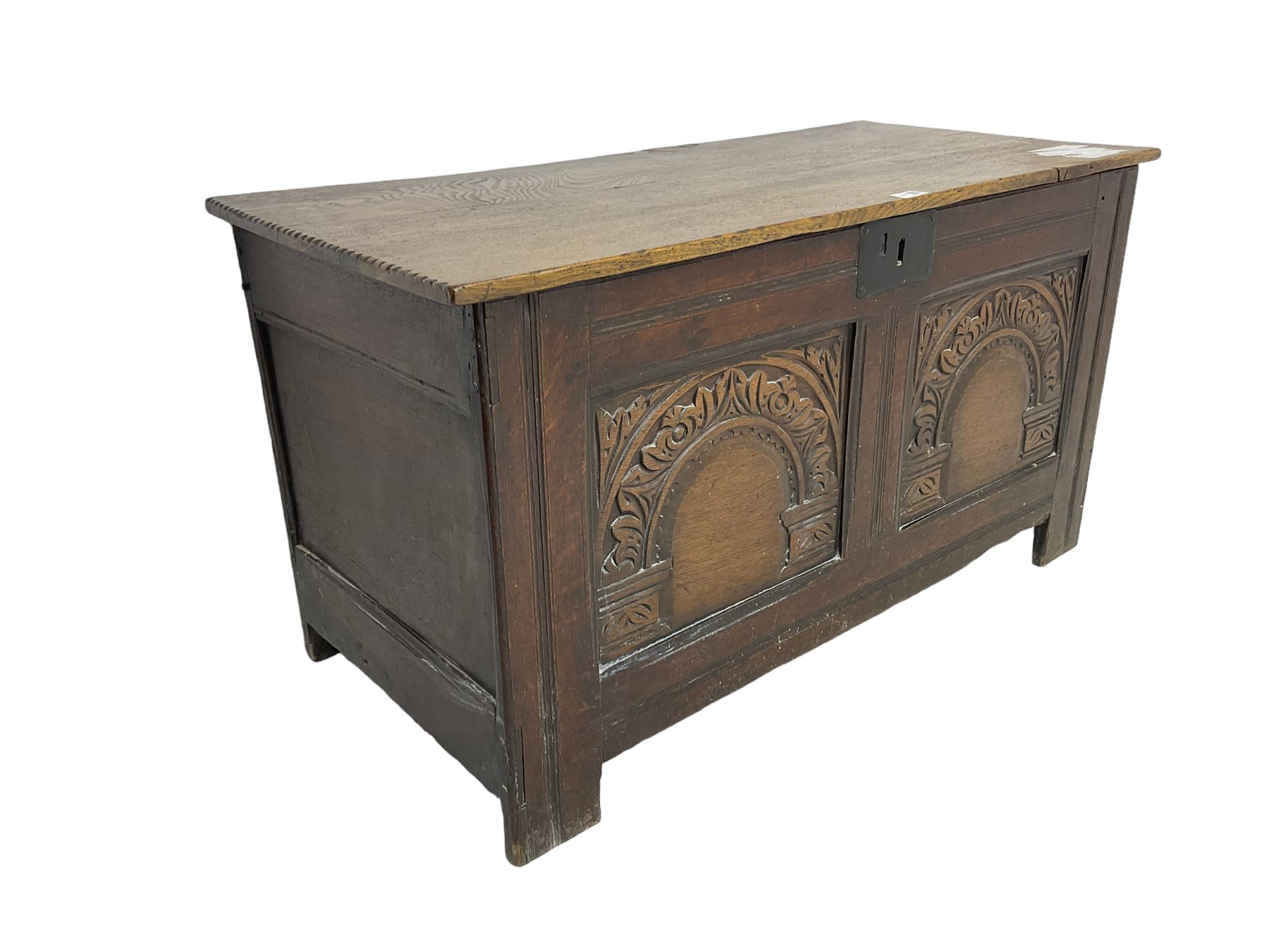 Jacobean Revival - 19th century oak blanket chest, rectangular hinged top, the two front panels carved arched foliate decoration, raised on stile supports