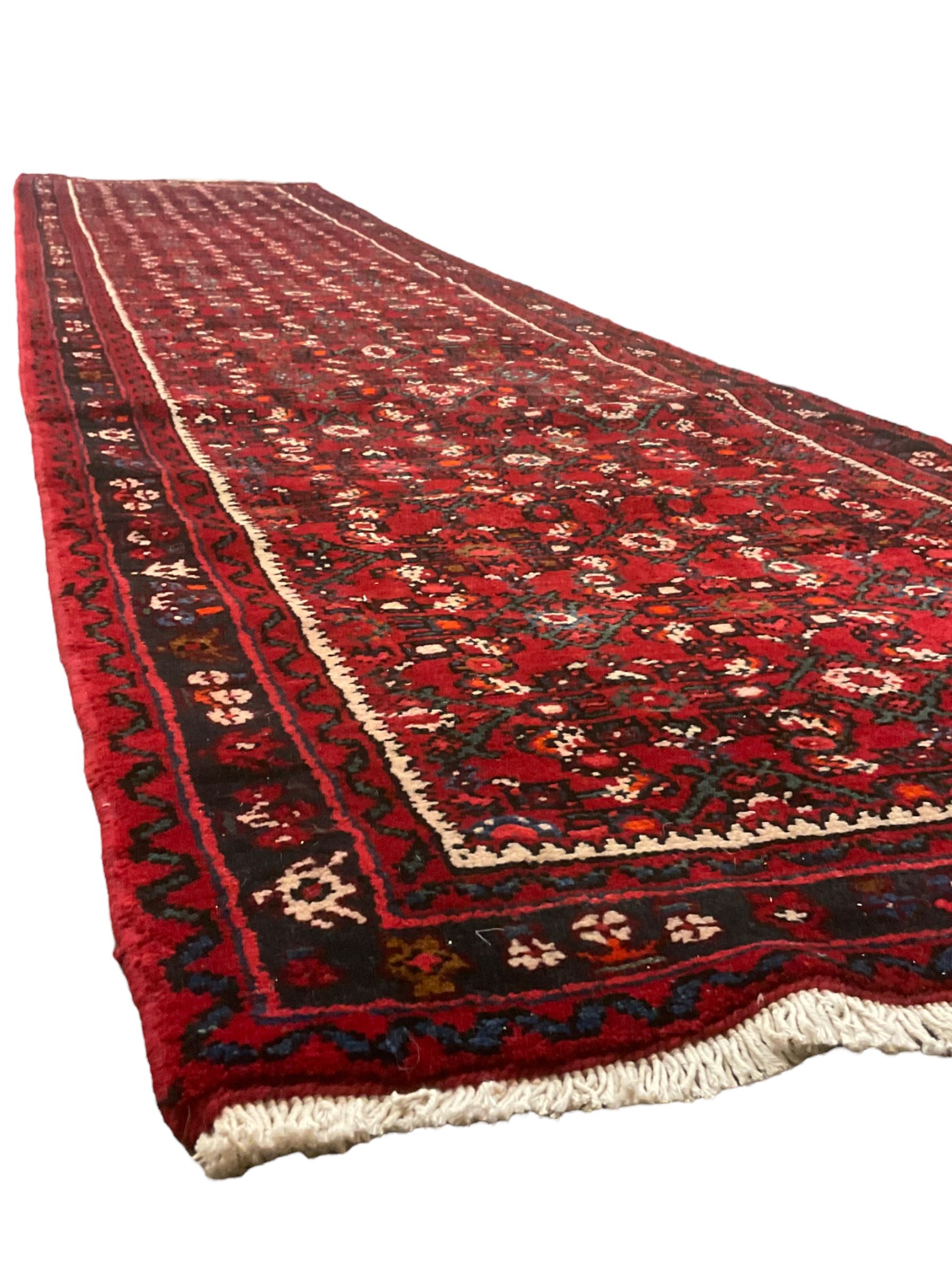 North West Persian Malayer runner, red ground field decorated with Herati motifs, guarded border decorated with trailing flowerhead band 