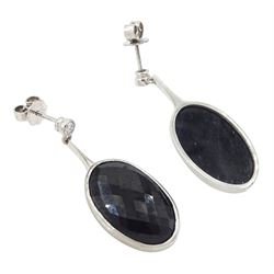 Pair of 18ct white gold sapphire and diamond pendant earrings, each stud set with a single round brilliant cut diamond, suspending an oval harlequin cut sapphire, hallmarked, total sapphire weight approx 31.30 carat