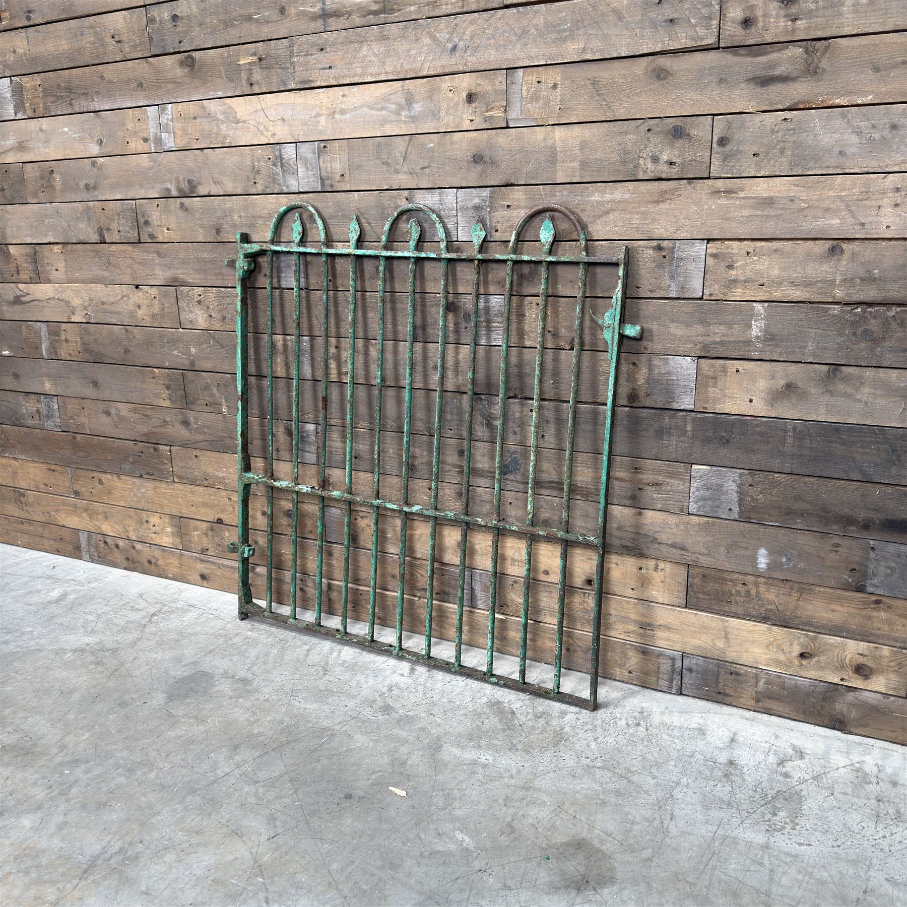 19th century French cast iron garden gate, finished in green rustic paint, bar form with hoop and spear top, with loop hinge brackets
