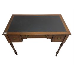 Late 19th century walnut writing table or desk, moulded rectangular top with inset leather, fitted with three drawers, on ring turned supports with brass and ceramic castors 