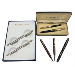 Group of Waterman pens and propelling pencils, to include a fountain pen, the black barrel with rolled gold cap and nib stamped 14ct, together with a matching propelling pencil, in box, together with a further fountain pen with gold nib stamped 14ct, stainless steel fountain pen and rollerball set in box, propelling pencil with maroon barrel etc, largest L13cm (7)