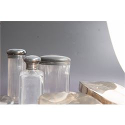 1920s gentleman's travelling case by Mappin & Webb Ltd, tan leather impressed with initials NAO, opening to reveal a compartmentalised interior containing silver mounted dressing table items, including a pair of silver mounted brushes, engraved NAO AMA 1918, hallmarked William Comyns, London 1911, five faceted glass jars and bottles with silver lids and a silver shaving brush holder, all hallmarked Mappin & Webb Ltd, London 1922, tan leather box containing razor, silver plated shoe horn, scissors and bevelled edge shaving mirror with easel support