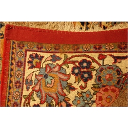  Persian multicoloured rug, floral field within repeating scroll border, 215cm x 134cm,   