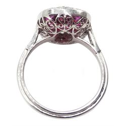 Platinum ring set with central oval ruby, halo of calibre cut rubies and halo of diamonds, with diamond shoulders
