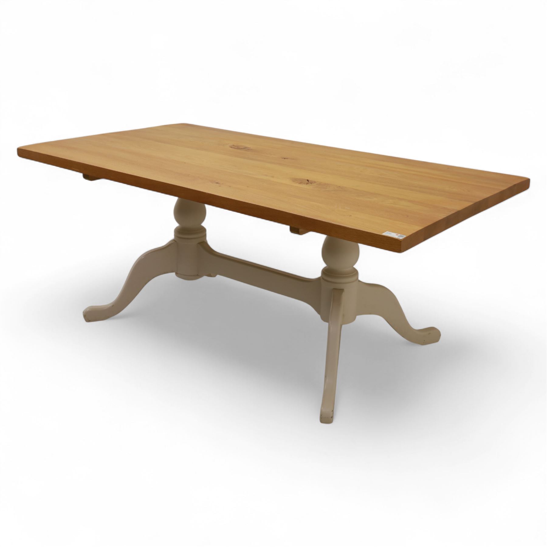 Contemporary light oak dining table, painted tripod bases with stretcher 