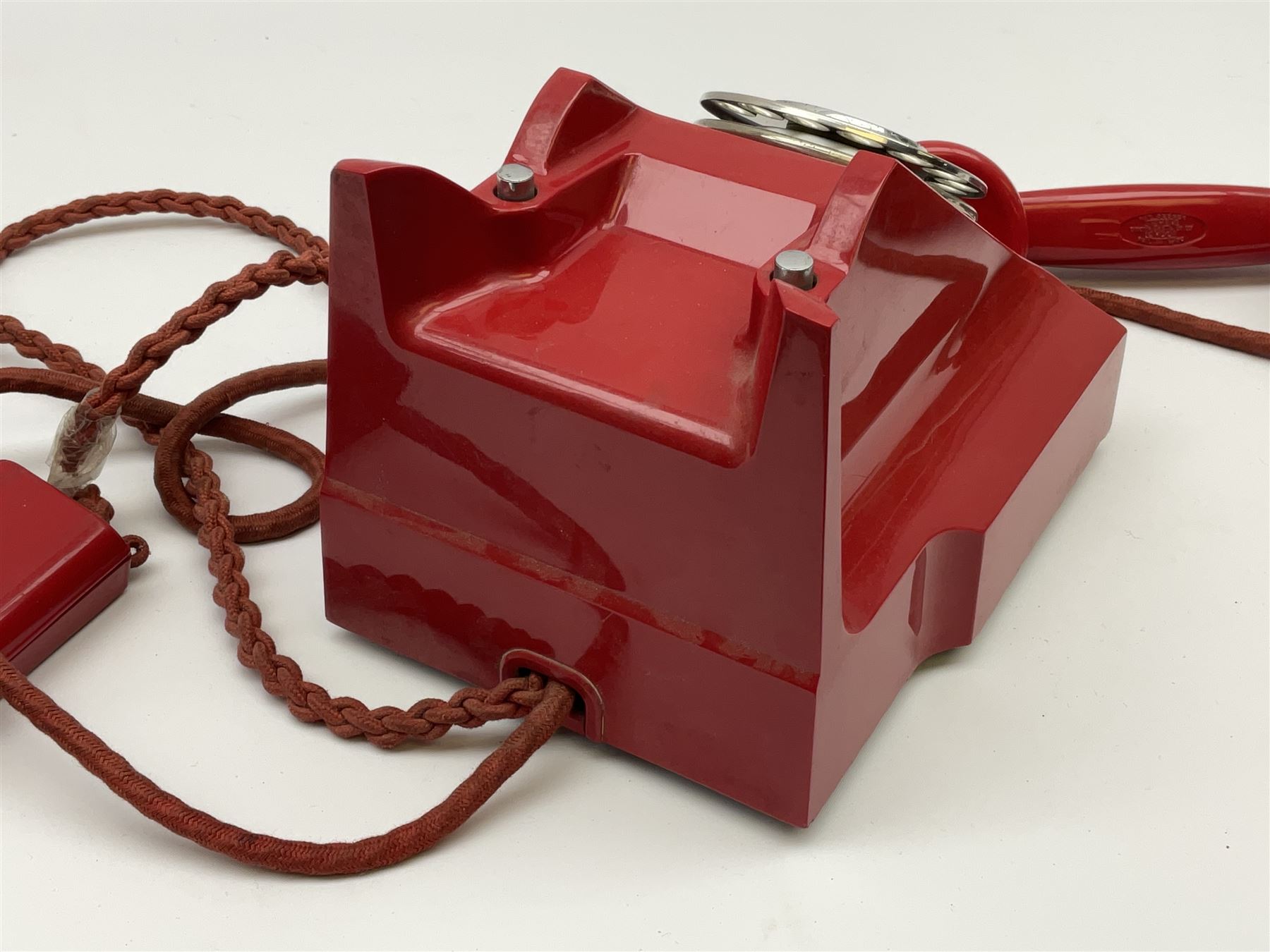 1950s Siemens Brothers red telephone with chrome rotary dial with enamel number plate and Siemens dial label, model 356, the body with base drawer below gilt logo, the handset with impressed mark PAT. 328926 PAT. SA 9/30, with red braided cord and red junction box (detatched), W15cm D18.5cm H14cm