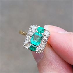 Early 20th century gold emerald and diamond panel ring, three octagonal cut emeralds, with four old cut diamonds set either side, stamped 18ct Plat, total diamond weight approx 0.85 carat