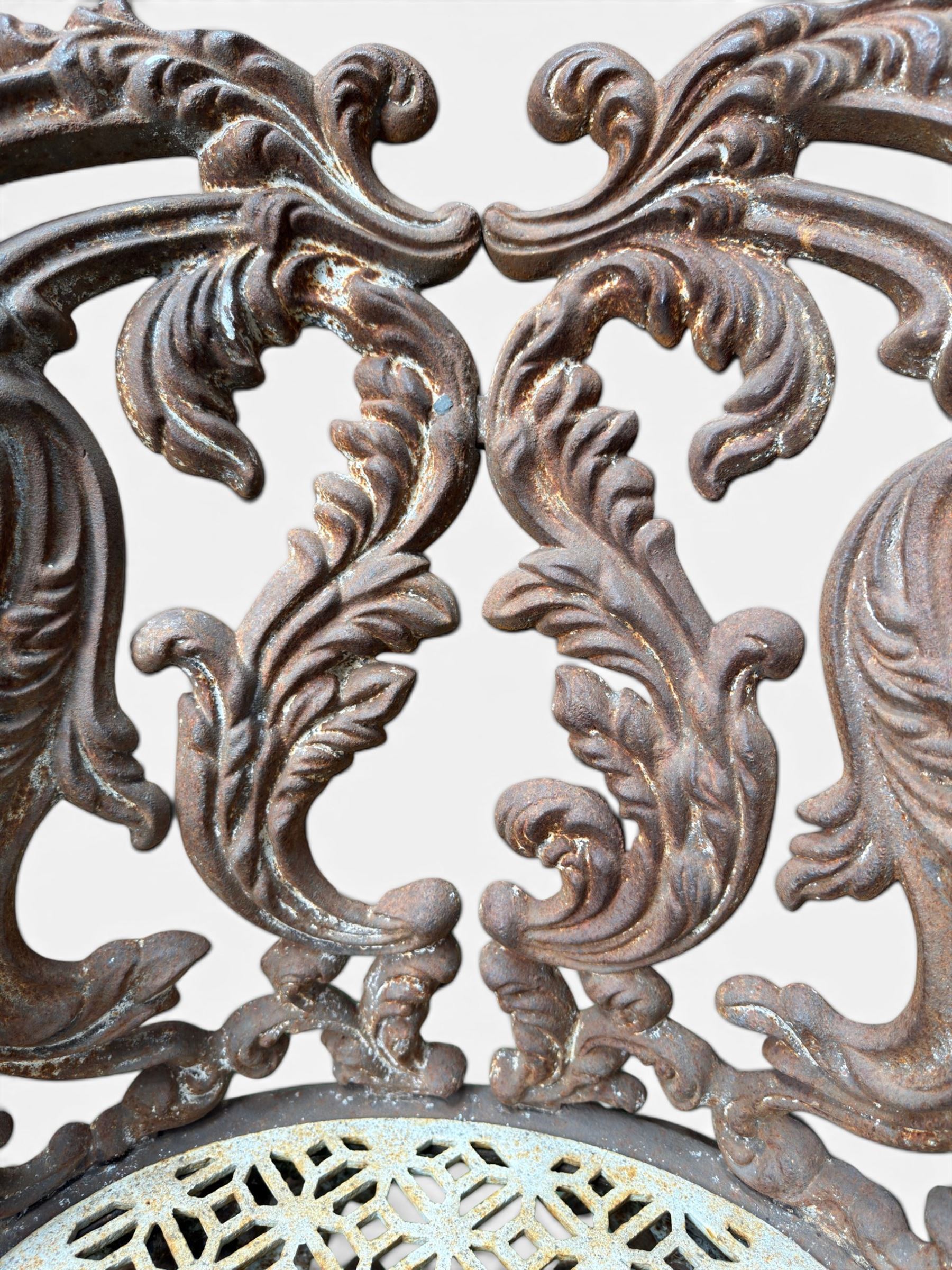 19th century Rococo Revival cast iron garden chair, pierced back comprised of scrolling acanthus leaves, over a pierced geometric white painted drop-in seat, raised on four acanthus and anthemion shaped cabriole supports united by X-frame stretcher