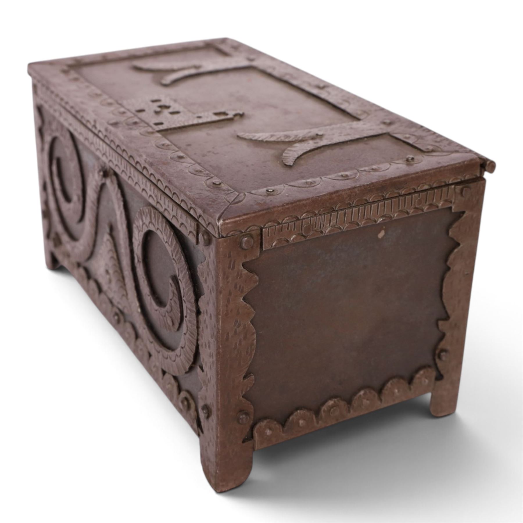 Late 19th/early 20th century vernacular iron box, the hinged cover and sides with applied strapwork decoration, the cover with applied church motif, H11.5cm W22cm D12cm