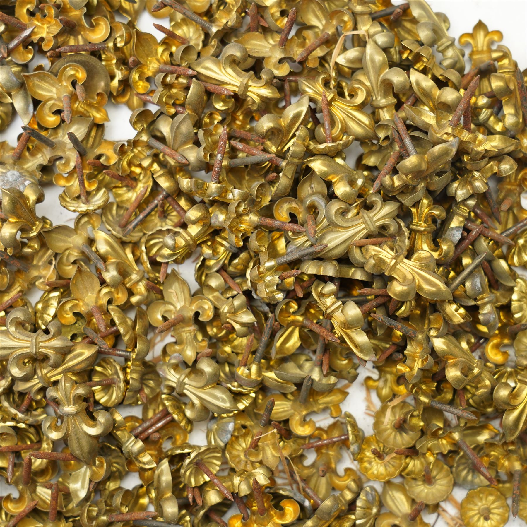 Large quantity of Victorian brass upholstery pins with rosette and fleur de lis designs 
Provenance: property of a Nobleman