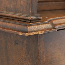 Arts & Crafts oak bureau bookcase, projecting cornice with leaded and glazed upper cabinet, the lower section with fall front section revealing a fitted interior, above shaped lower shelving 