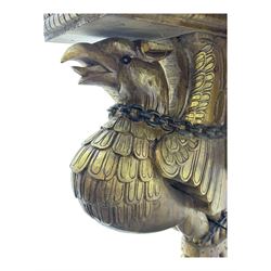 19th century Renaissance Revival carved and giltwood centre table, the rectangular top with gadrooned edge and carved frieze of repeating arched motifs with stylised scrolls, supported by a pair of carved winged griffin supports restrained by a central chained figure, on stepped rectangular bases united by carved stretcher