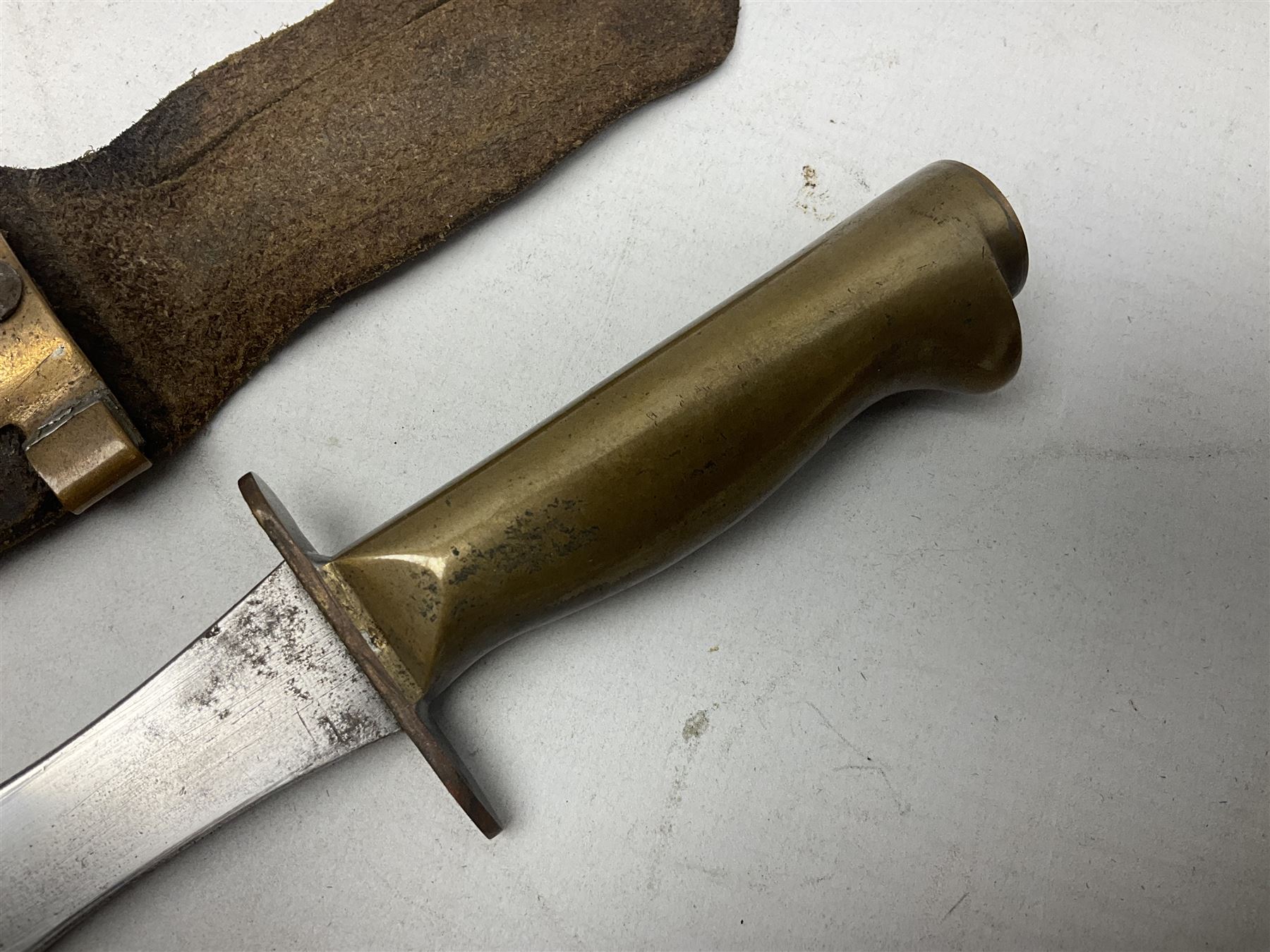 Scratch-built fighting/throwing knife, probably trench art, with 18cm steel spear type blade, plain cross-piece and French Lebel Rifle bayonet grip; in bras mounted studded leather sheath with belt hanger L29.5cm overall