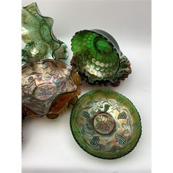 A collection of Carnival glass, to include marigold, green, and amethyst, bowls, dishes, and comports, various patterns including fruiting vines, peacocks, and an example decorated with a Horseshoe and detailed Good Luck. 
