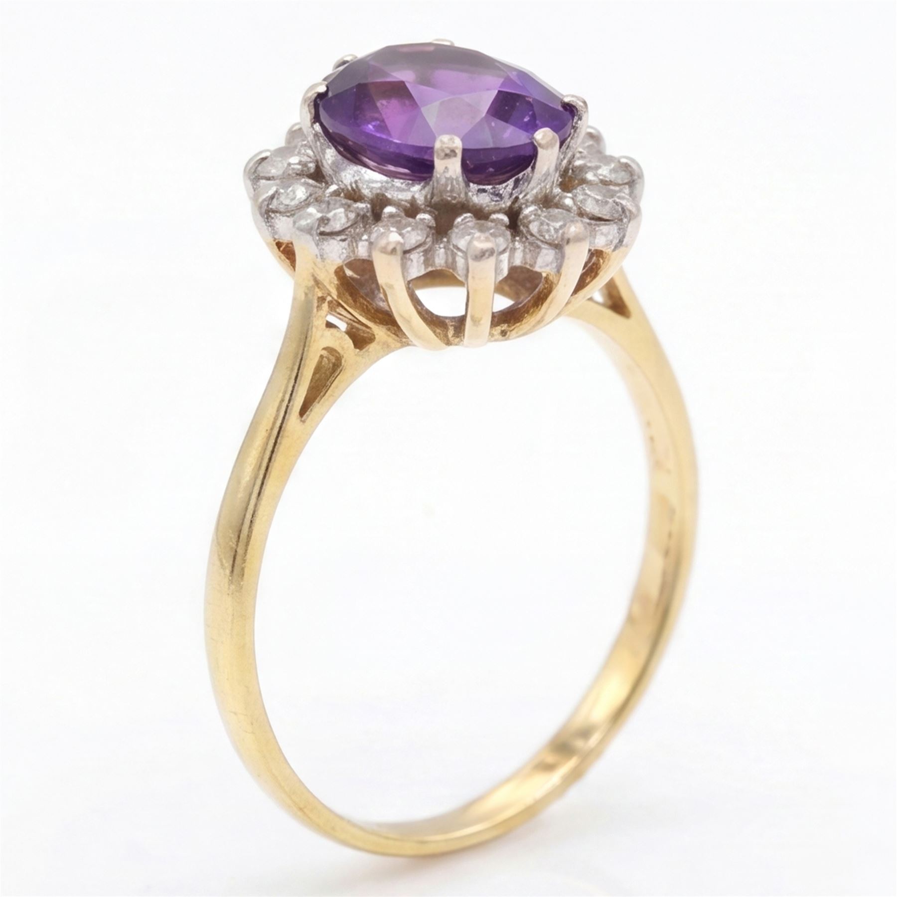 18ct gold amethyst and diamond cluster ring, single oval cut amethyst surrounded by sixteen single cut diamonds, London 1967