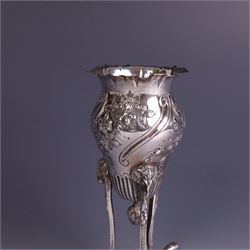 Late Victorian silver vase, of baluster form with fluted rim, the body with embossed floral decoration, upon three tall legs with ramshead mounts, hallmarked William Comyns & Sons, London 1890, H13.5cm